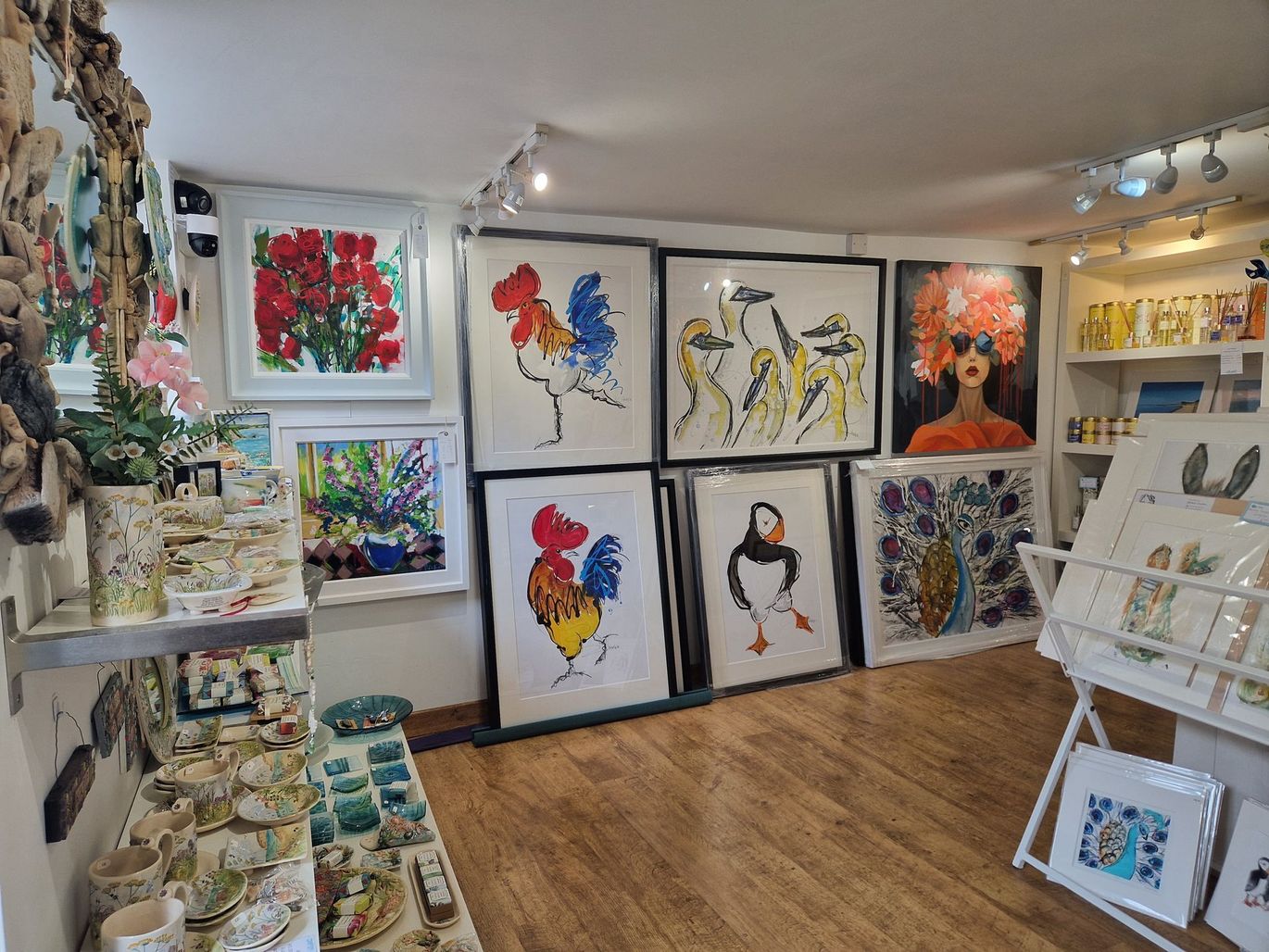 Ceramics on shelves and paintings on the wall, Azure Gallery interior